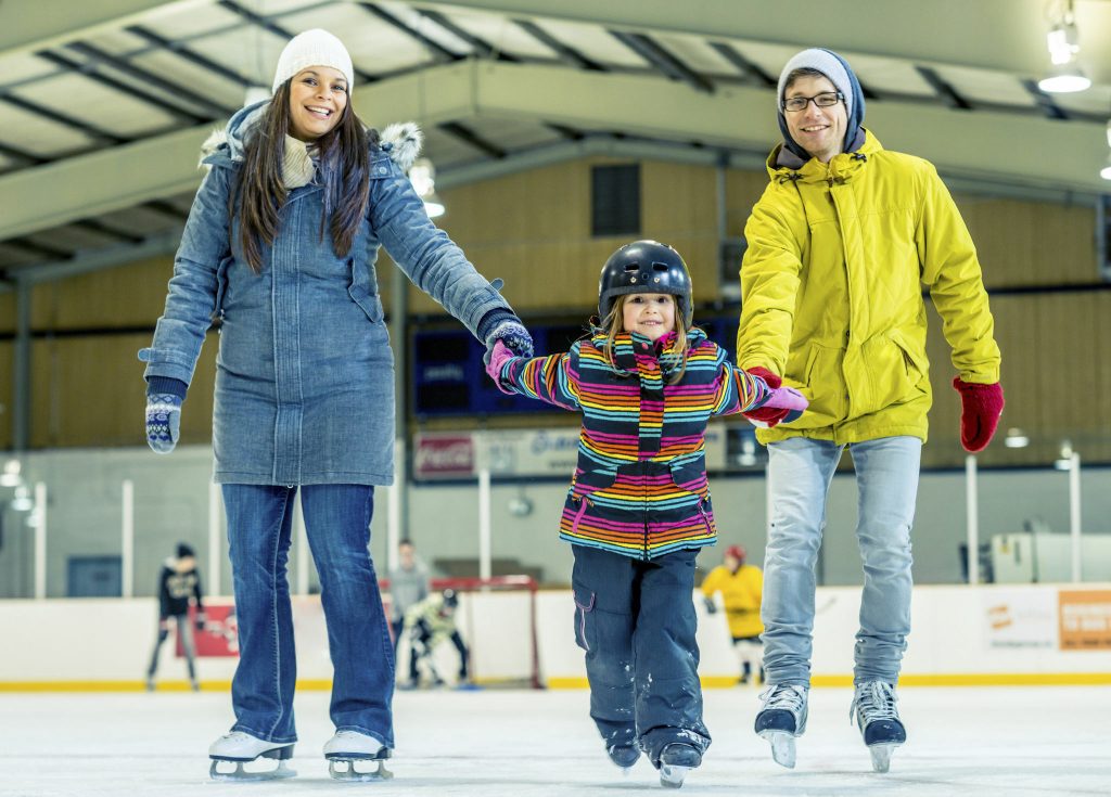 Family ice skating at the Village in Sunriver, one of the best winter activities